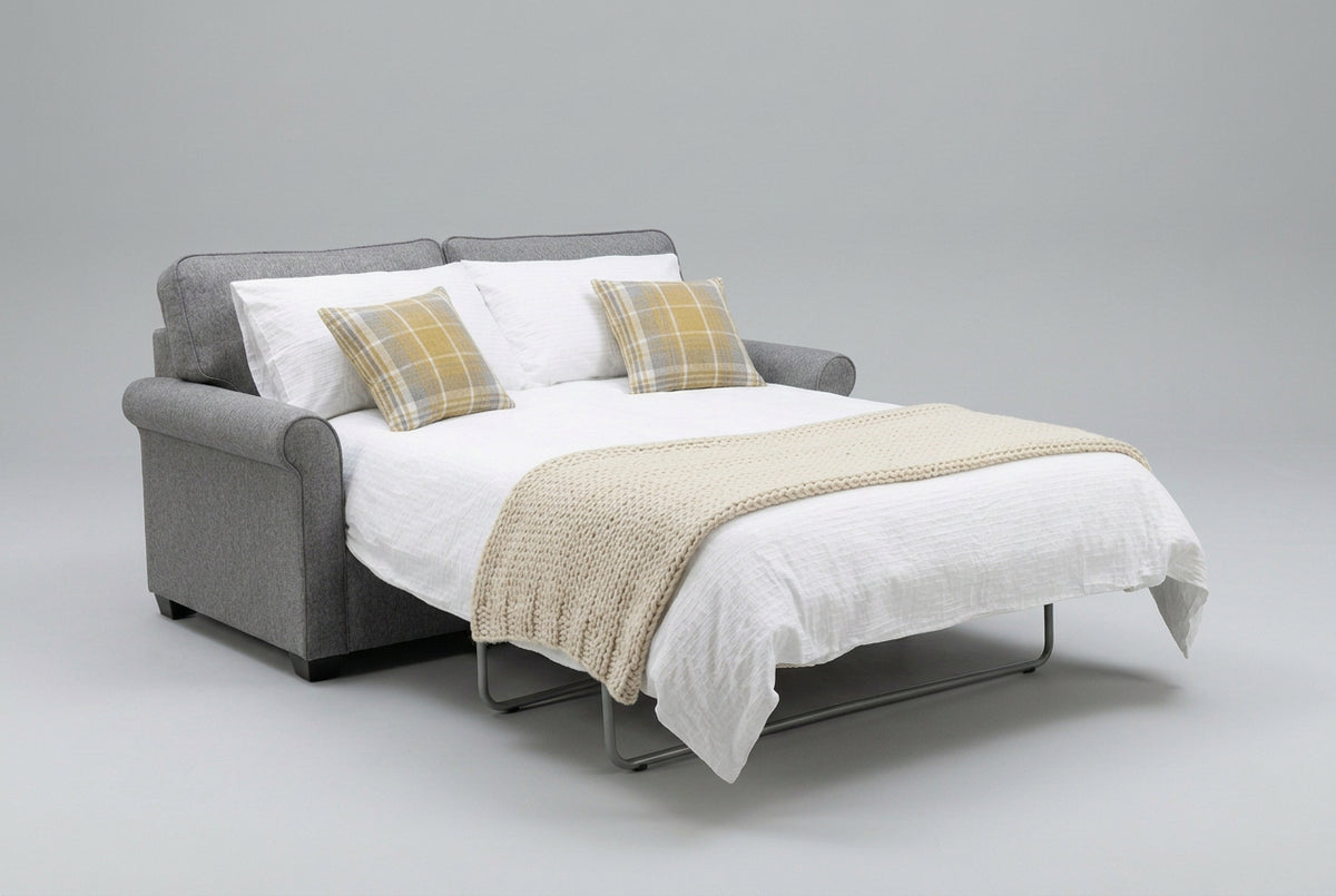 Alstons Poppy Sofa Bed, Open displayed in  Grey with Plaid scatter cushions in studio setting 