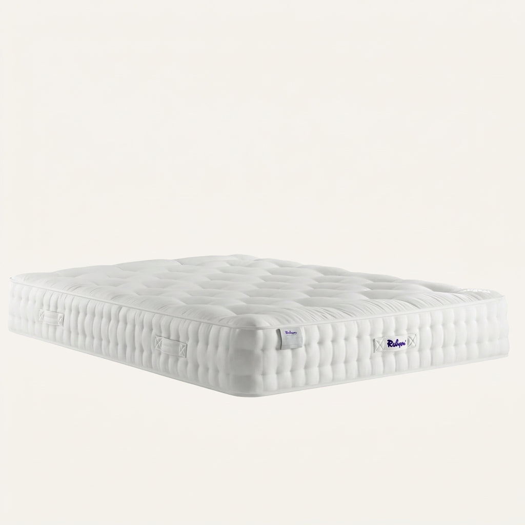 A white quilted mattress shown at a three-quarter angle on a solid white background, featuring a visible 'Relyon' brand label on the side.