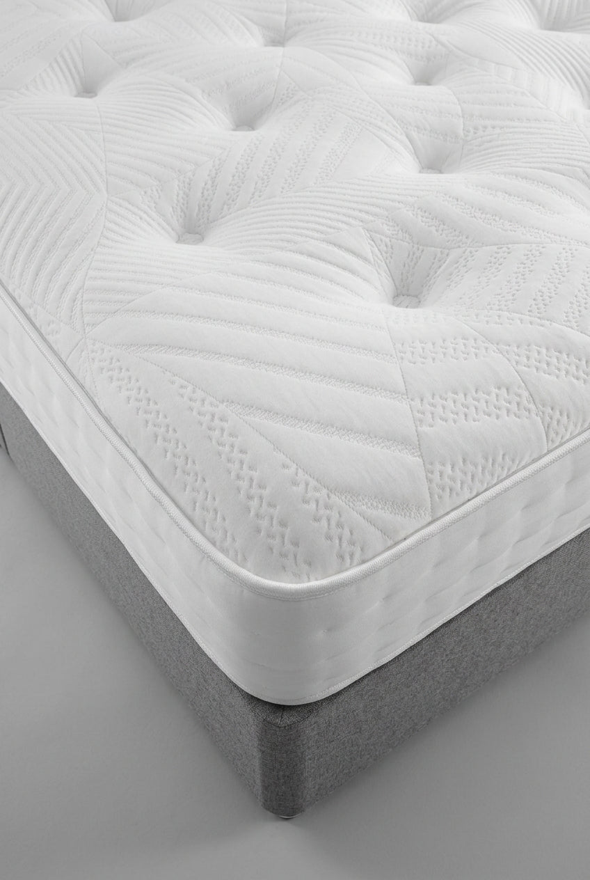 Ashford Bed Centre Belvedere 1000 Pocket Sprung Mattress showing its tufted surface and corner on a grey bed base
