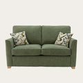Alstons Reuben sofa bed in green upholstery with two patterned scatter cushions
