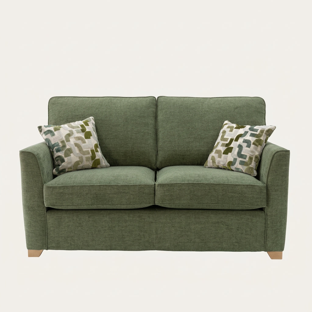 Alstons Reuben sofa bed in green upholstery with two patterned scatter cushions
