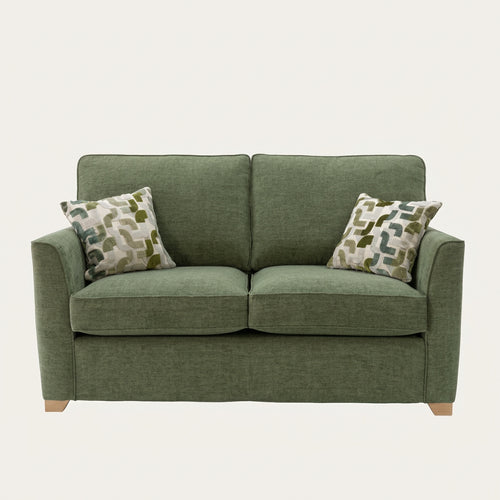 Alstons Reuben sofa bed in green upholstery with two patterned scatter cushions
